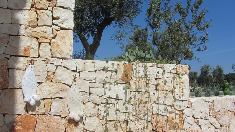 Local ceramic 'Fico d'India' against the dry stone wall