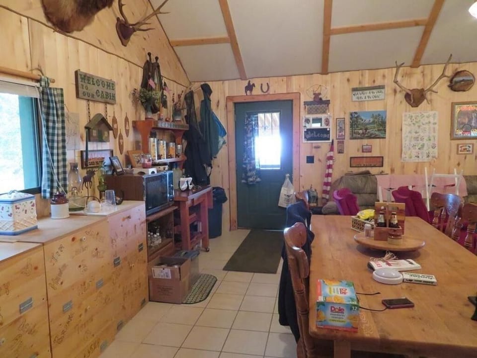 Door (there are 2 ) to deck and fire pit. Large dining table and pantry 