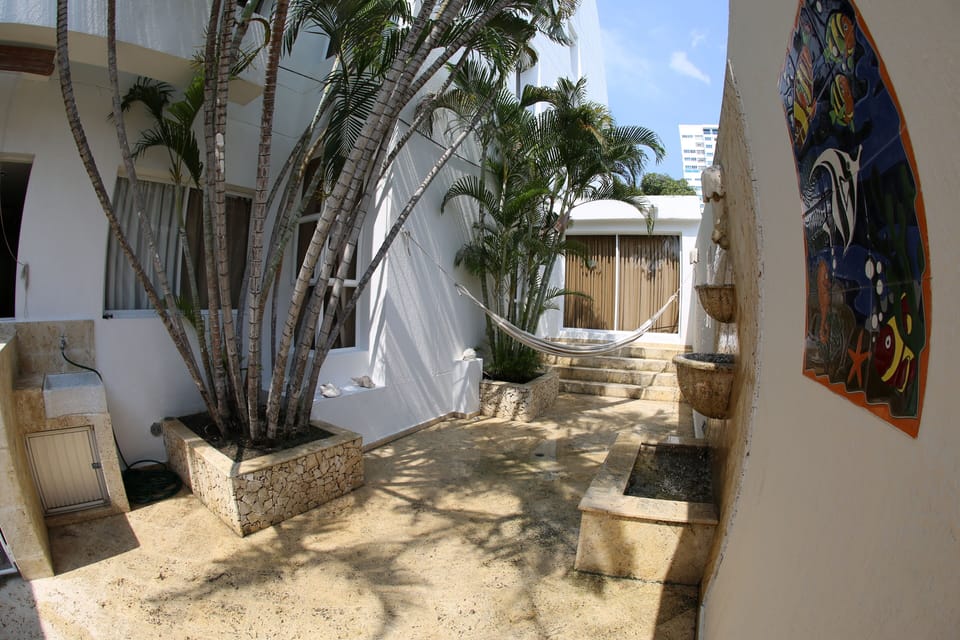 Large Inside Patio with stone coral water fountain and 2 hammocks   