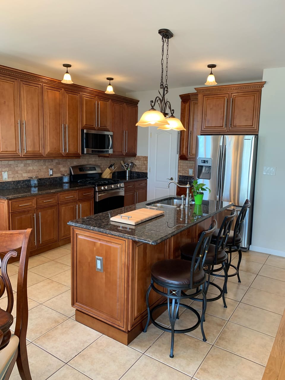 Beautiful kitchen with granite counter, top notch appliances, and large pantry