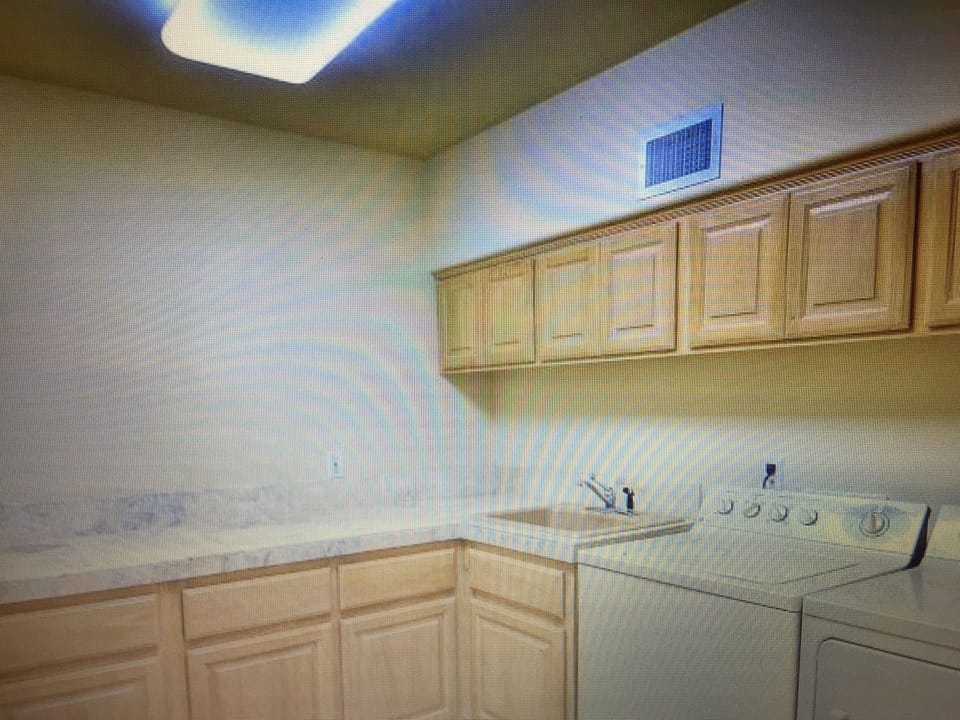 Large laundry room with washer, dryer and sink.