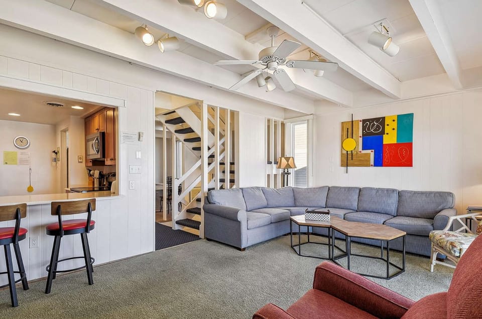 Living Room on the main level with steps to level 1 and breakfast nook seating.
