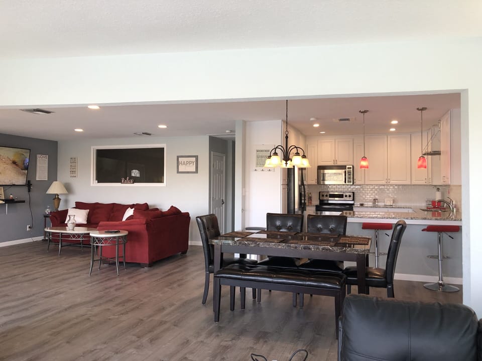 A view from the sectional of the dining room with the kitchen in the background