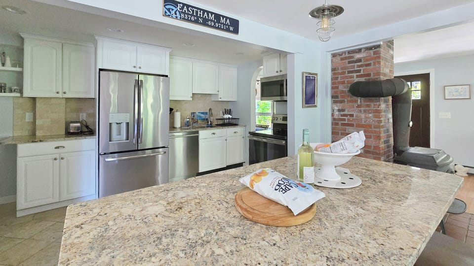 Kitchen with large center island and stainless appliances