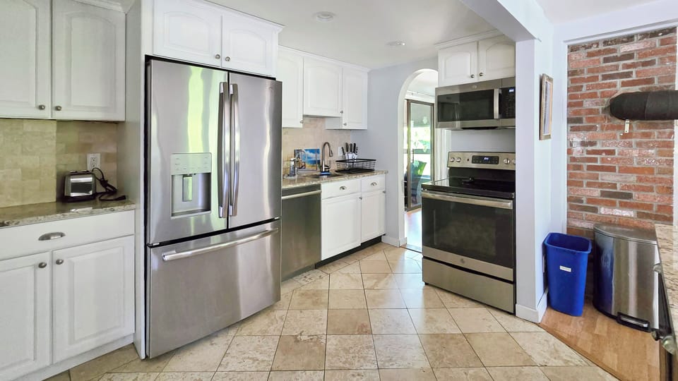 Kitchen with large center island and stainless appliances