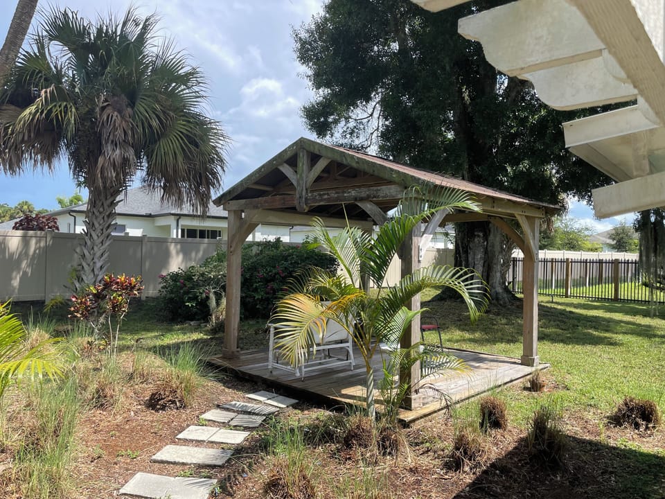 Gazebo and Florida foliage - crotons, bougainvillea, palm and oak trees 