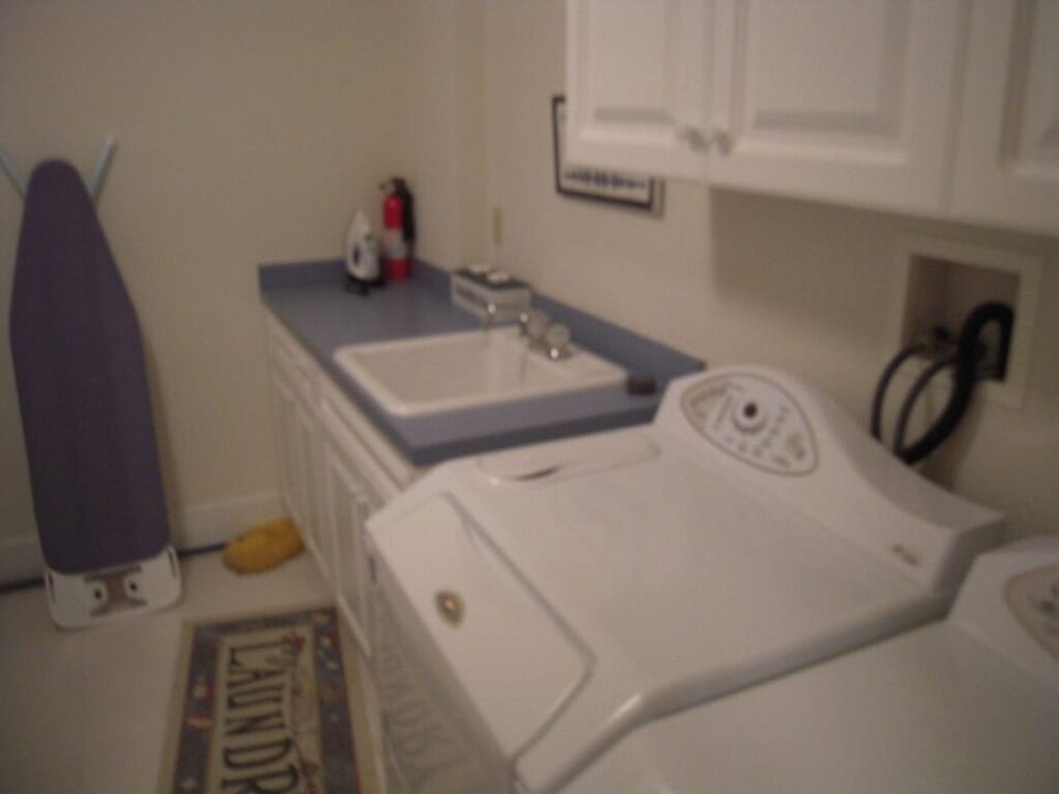 Laundry room with full size washer and dryer. Large laundry tub