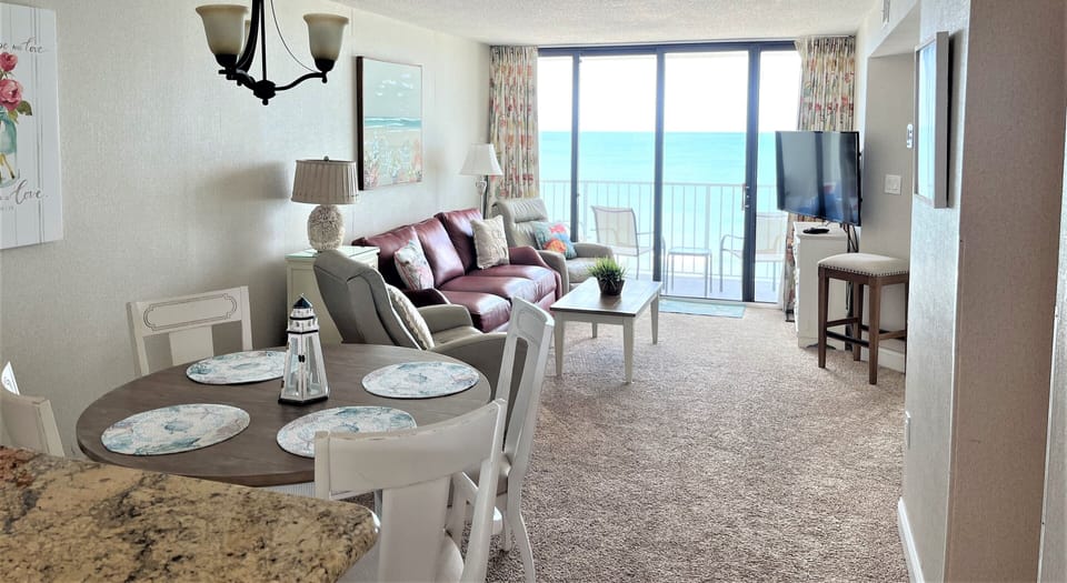 Living room and dining area overlooking ocean