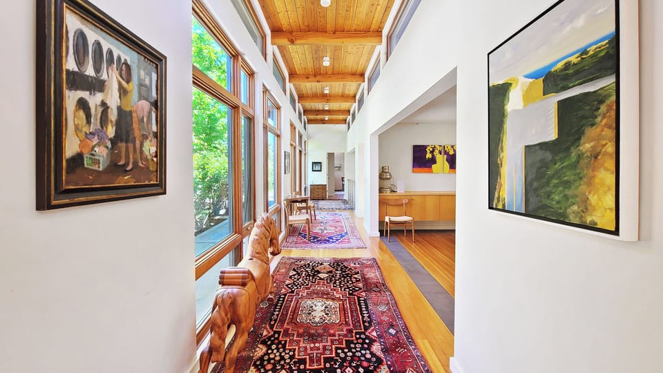 Hall leading past dining room heading towards primary bedroom and pool
