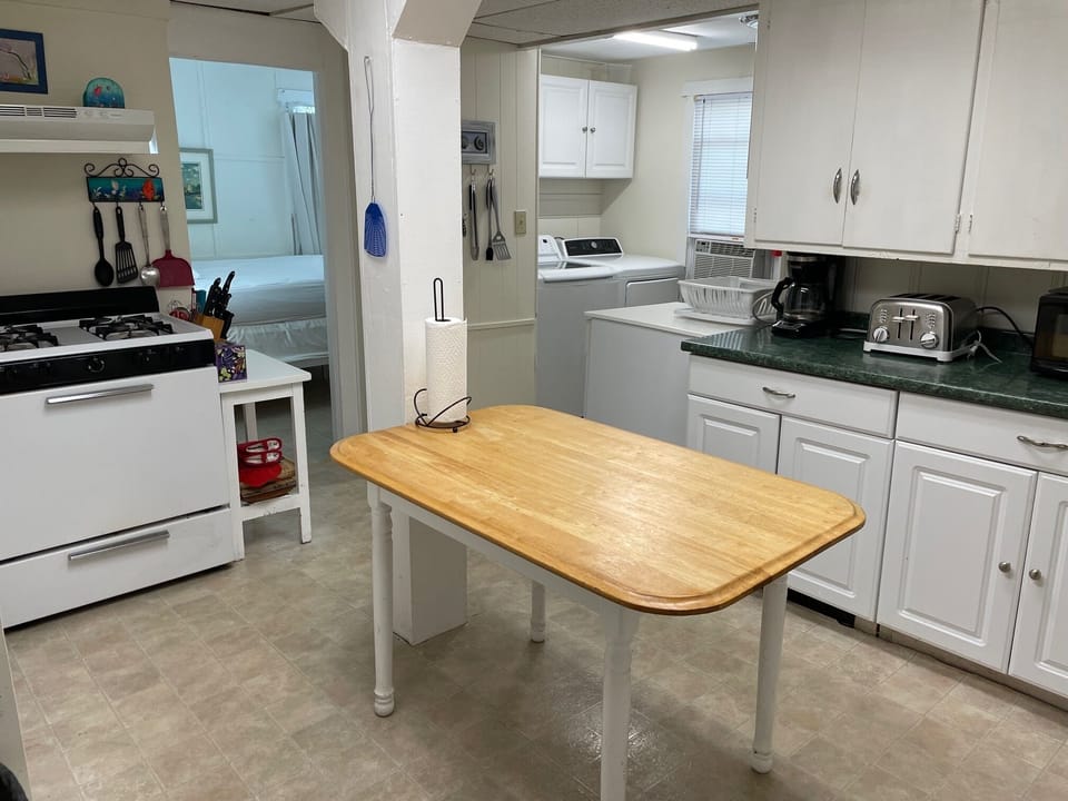 kitchen with view of laundry area and downstairs bedroom