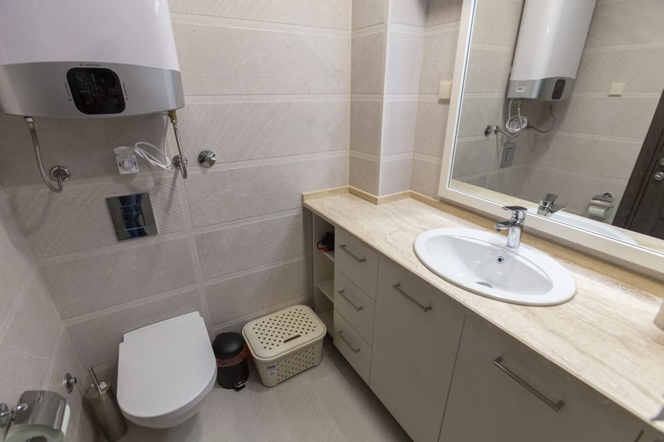 Private bathroom with clean towels, shower and hair dryer.
