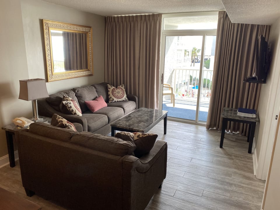 Living room area with balcony door and Smart TV
