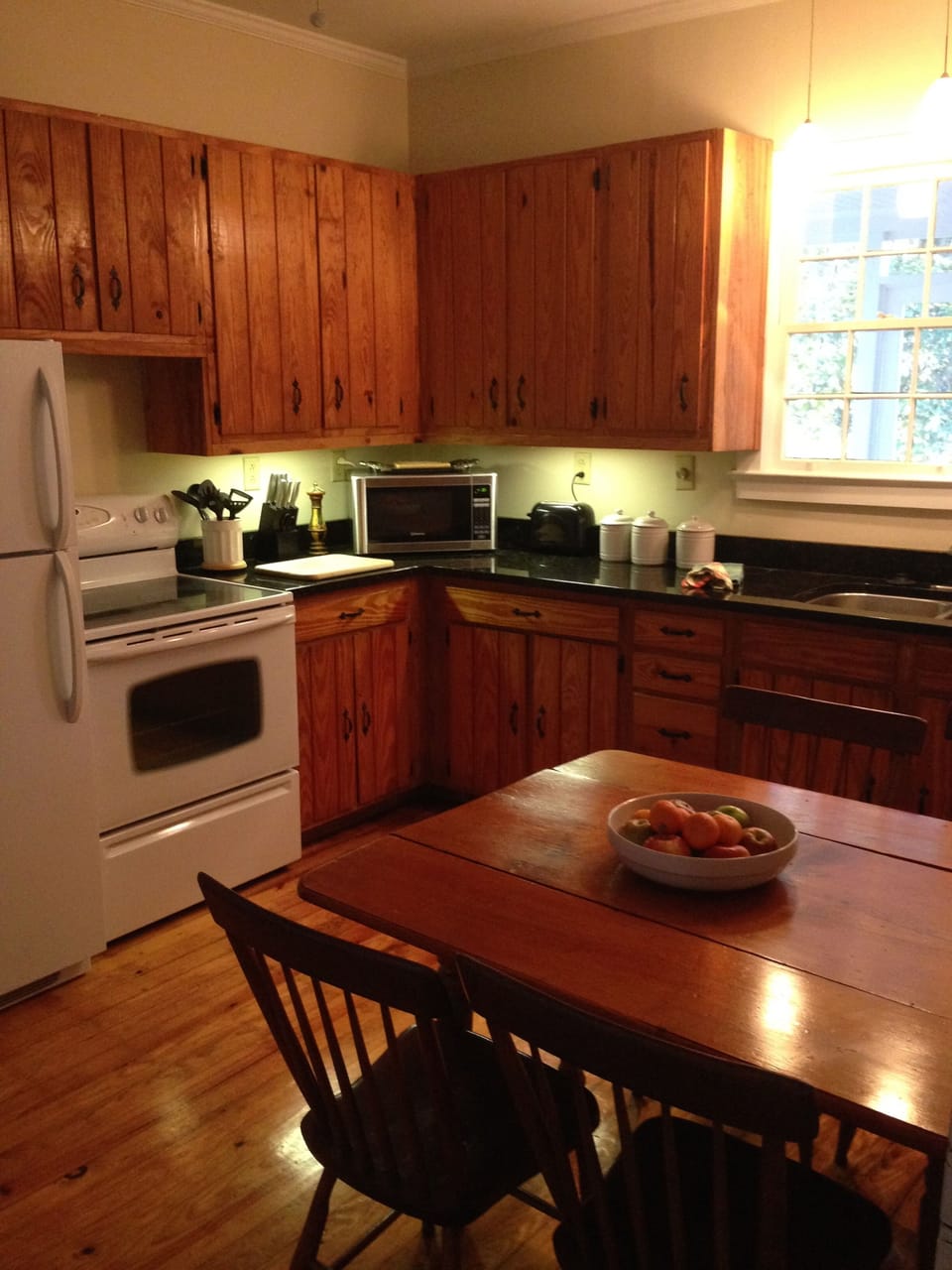 Fully equipped kitchen: microwave, coffee maker, condiments.