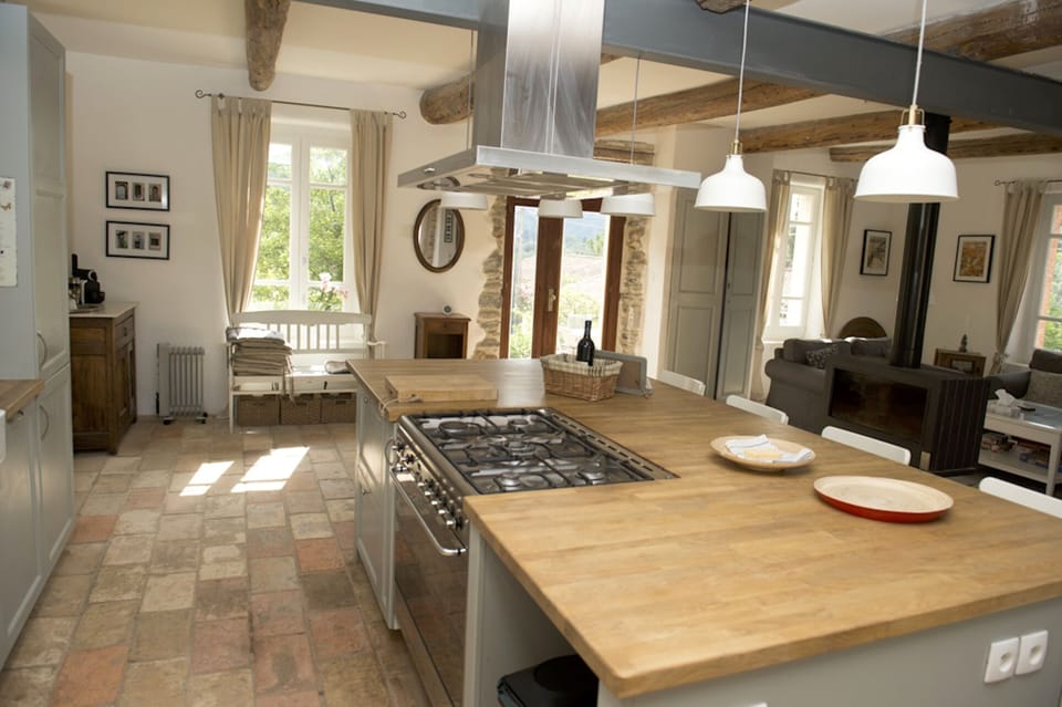 Gourmet kitchen looking towards coffee nook, entrance, and living room