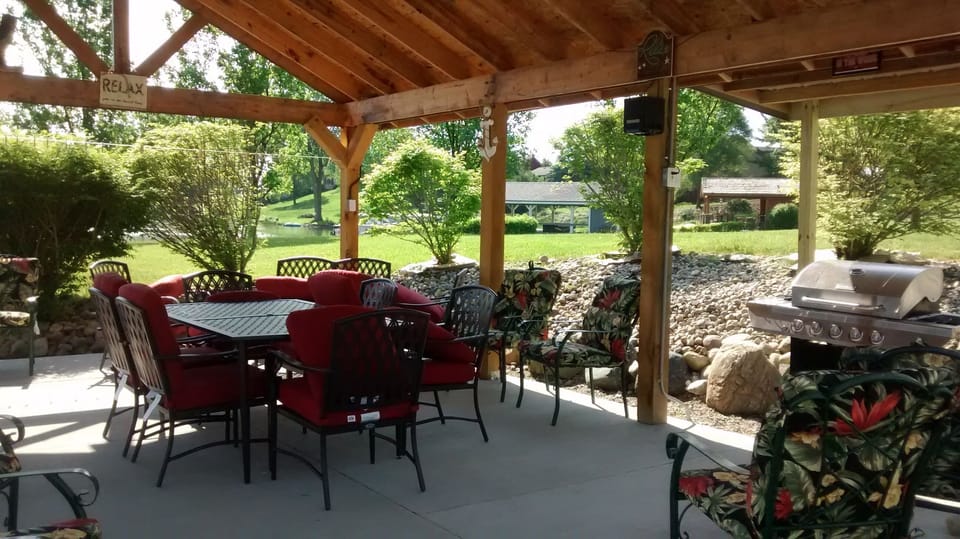 Outdoor Dining table with 16 soft chairs.  Cushioned Loveseat and side chairs.