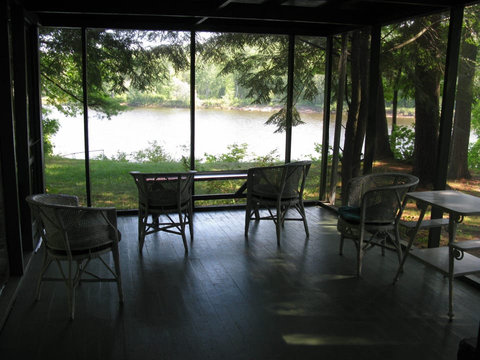Relax on the screen porch and watch the river glide by.