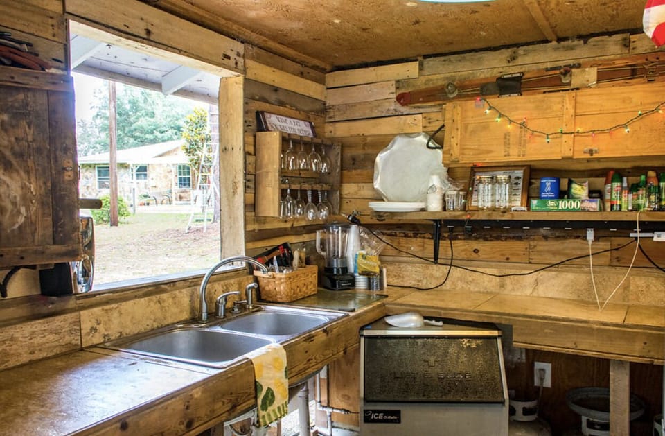 Outdoor kitchen/bar with commercial ice maker.