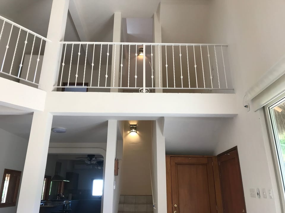 2nd floor balcony & stairs to 2 additional bedrooms, both w/ ensuite bathrooms