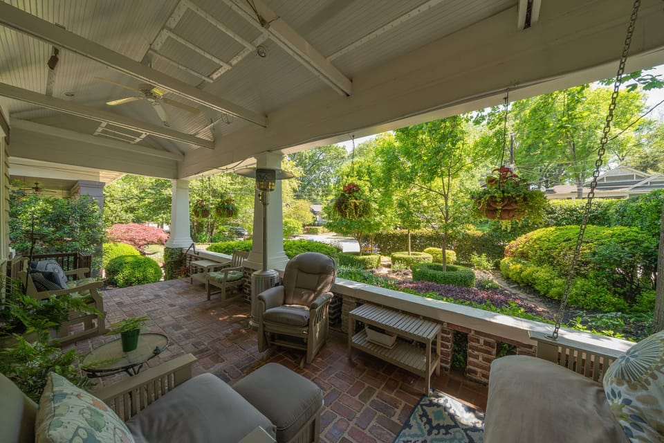 Front porch overlooks a beautifully manicured, private garden