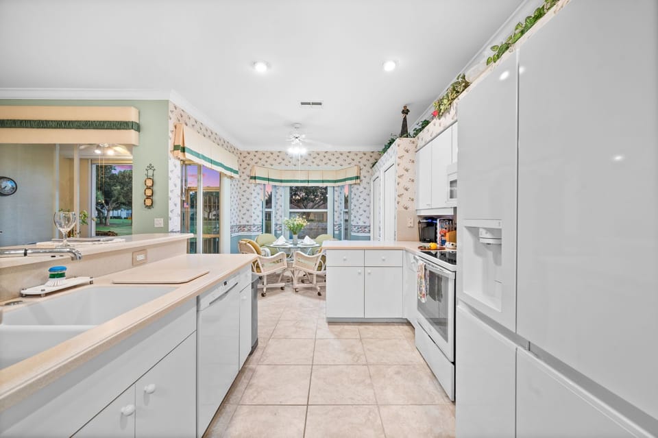 Gourmet Kitchen faces sunny rear gardens with Sunrise & Sunset Views!