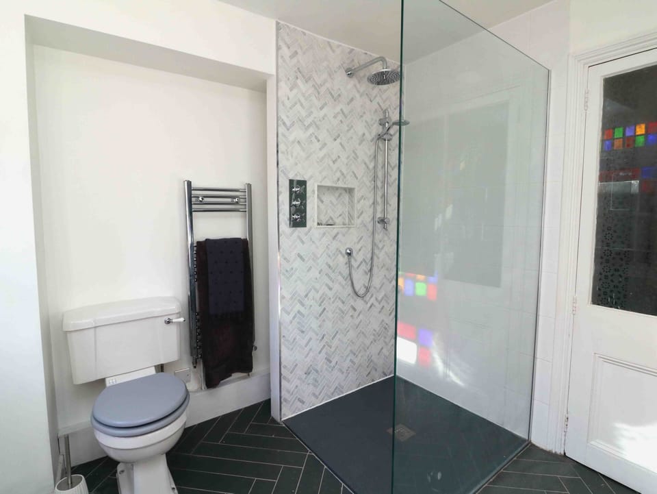 Downstairs laundry and shower room with access to rear courtyard.