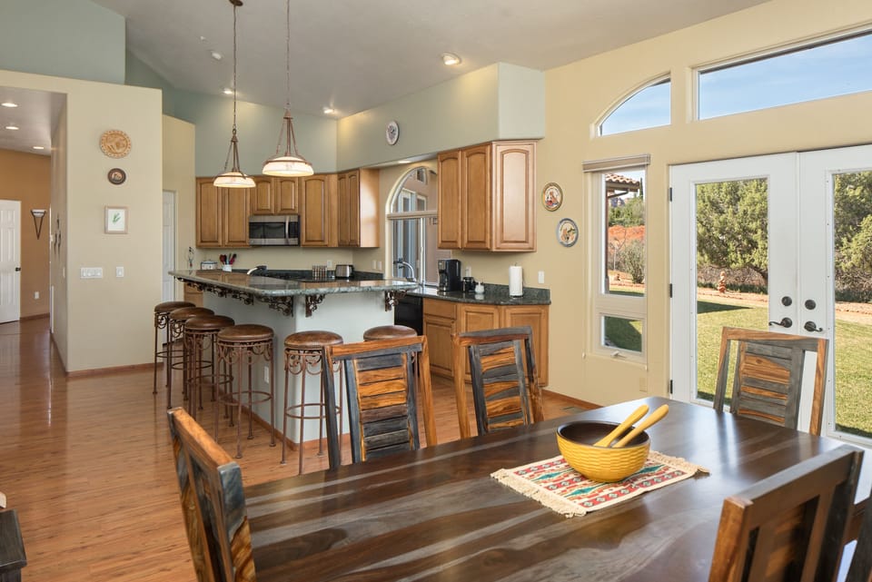 View of Kitchen with Dining table that seats 8 plus six bar stoles.
