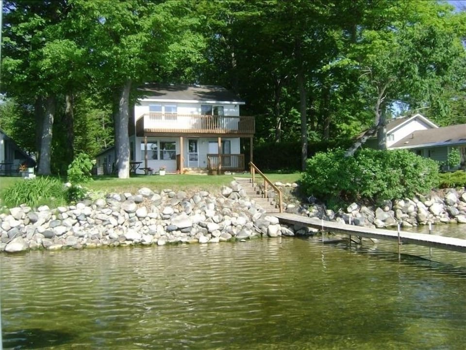 Lakefront - Rock breakwall - All sandy bottom. Ladders at both ends of dock.