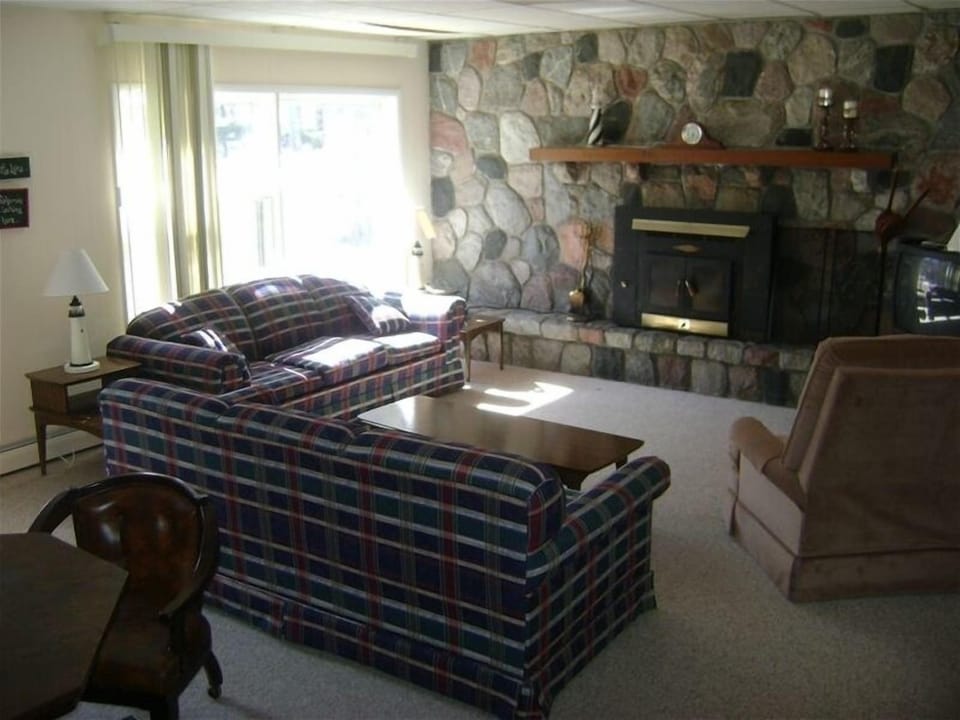 Family Room with wood burning fireplace. Games table for fun.