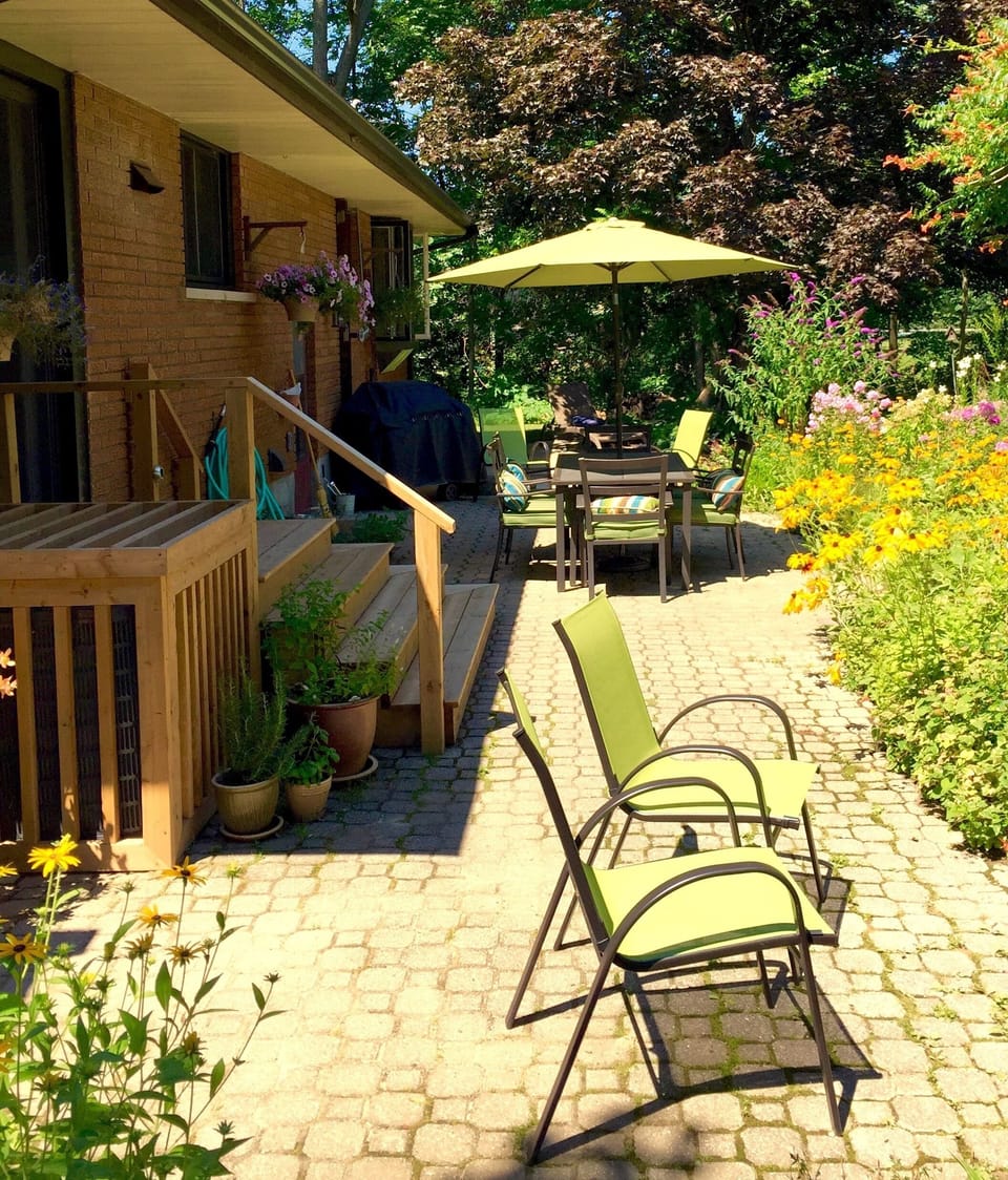 The rear patio is a sunny spot to have a conversation.