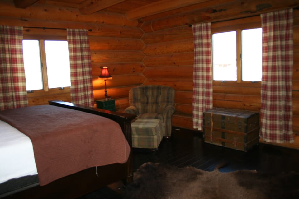 MASTER BEDROOM
king sized bed, oversized chair, bear skin rug