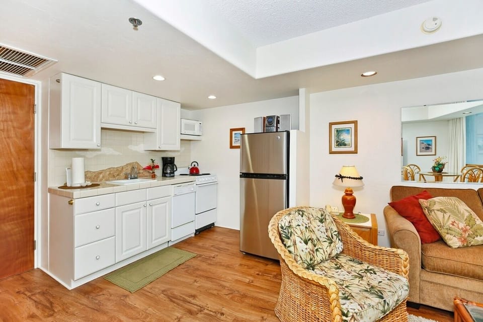 Kitchen with full-sized fridge, stove, microwave, mini-dishwasher.