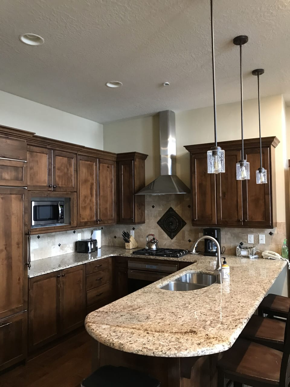 Kitchen stocked with cooking and serving pieces.  Wine refrigerator.