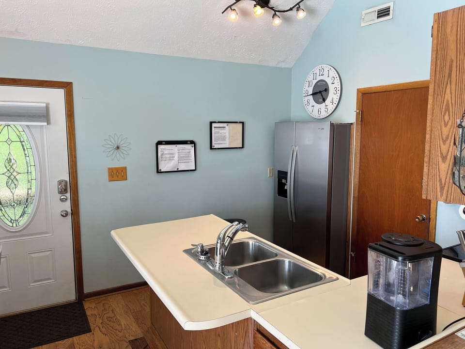 Entrance way and full kitchen with full pot drip style coffee maker
