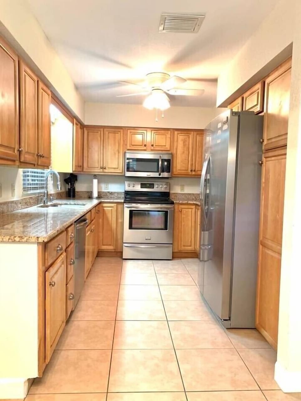 Renovated kitchen with granite counter top and new stainless steel appliances.