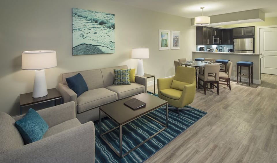 another view of the living room with kitchen at back