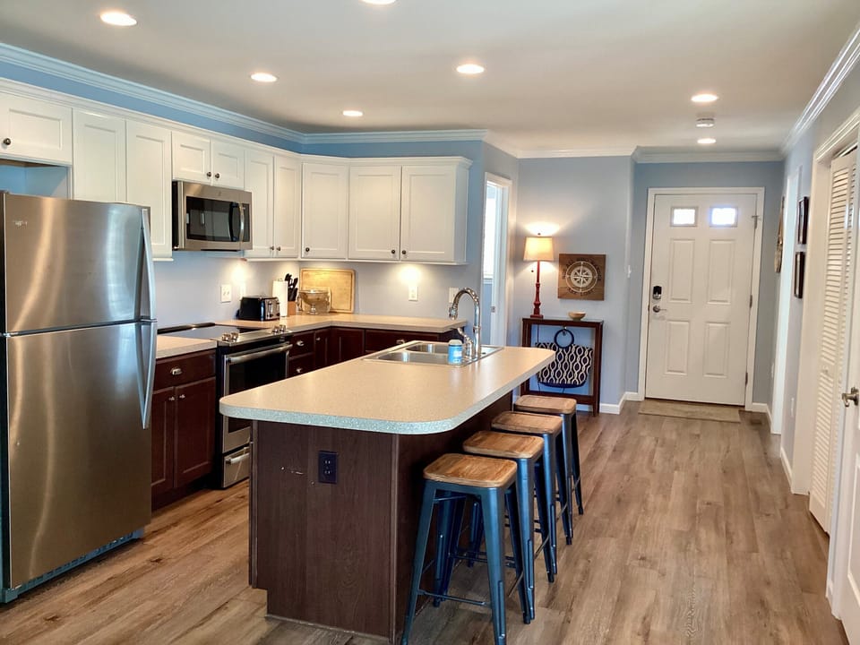 Kitchen is open to living spaces with conveniently located laundry closet. 