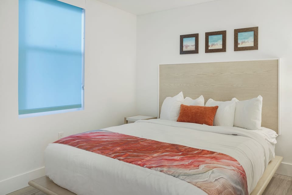 Queen guest bedroom contains dresser and closet space to unpack and unwind.