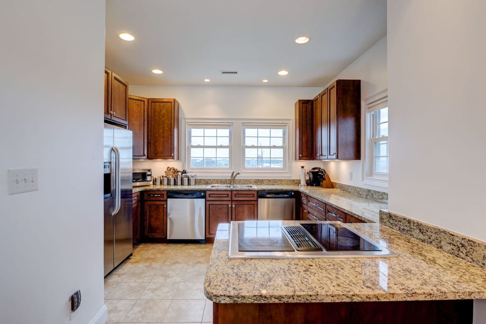 The kitchen is on the top level, featuring a Jenn Aire oven & 2 dishwashers!!