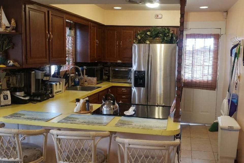 Another angle of kitchen; stainless steel fridge.