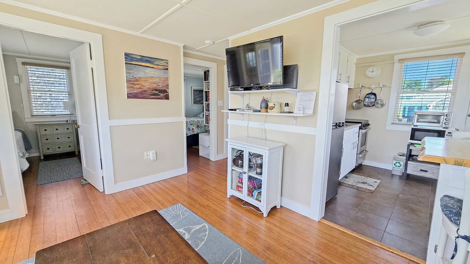 Living room has a comfortable sectional and flat screen TV