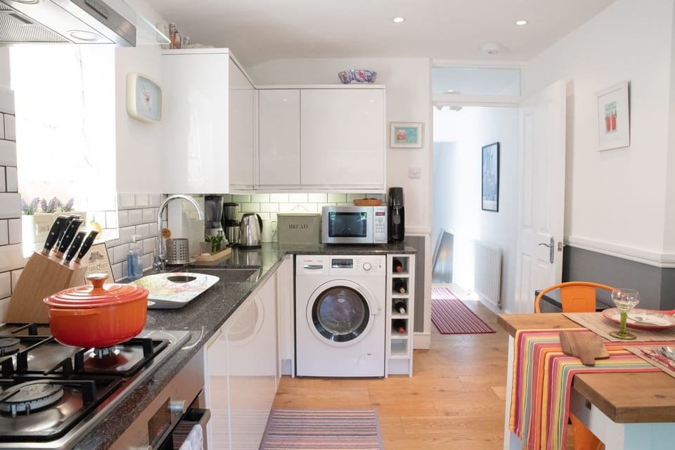 The kitchen has plenty of space to cook as well as a washer dryer combo. 