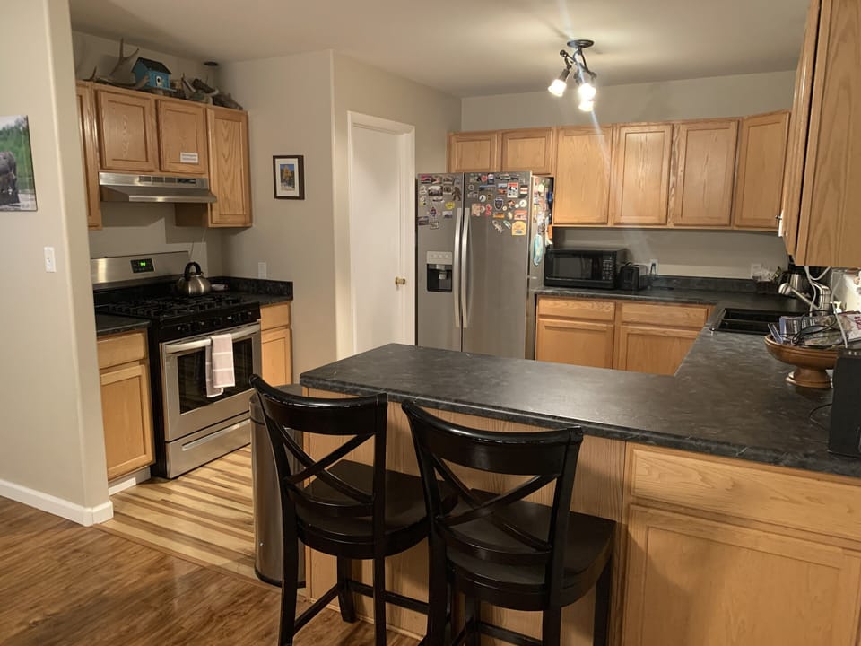 Open kitchen with all new stainless steel appliances 
