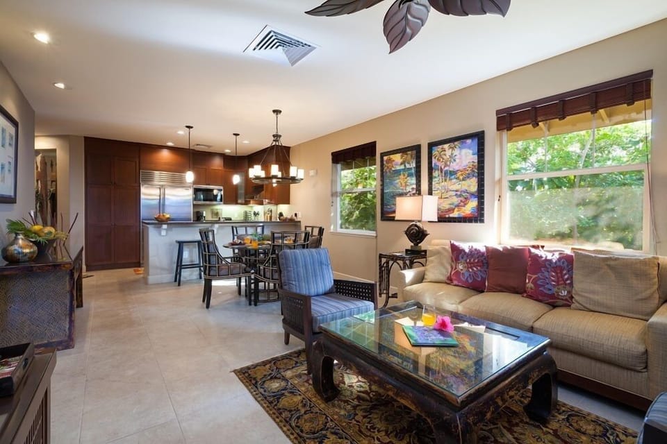 Open concept layout connects living room, dining area, and kitchen