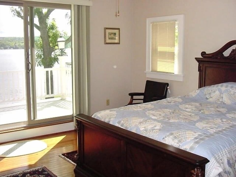 Upstairs bedroom with sliding door to private porch overlooking lake