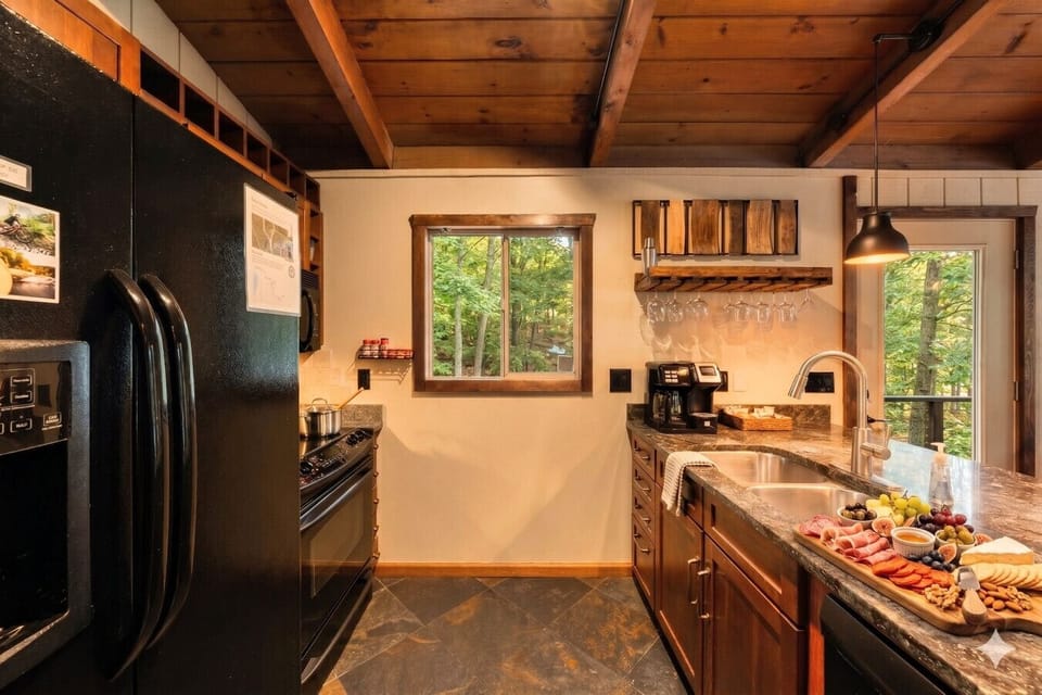 Fully equipped kitchen with coffee bar, wine glasses, and everything needed for family meals after a day at Torch Lake or Schuss Mountain.