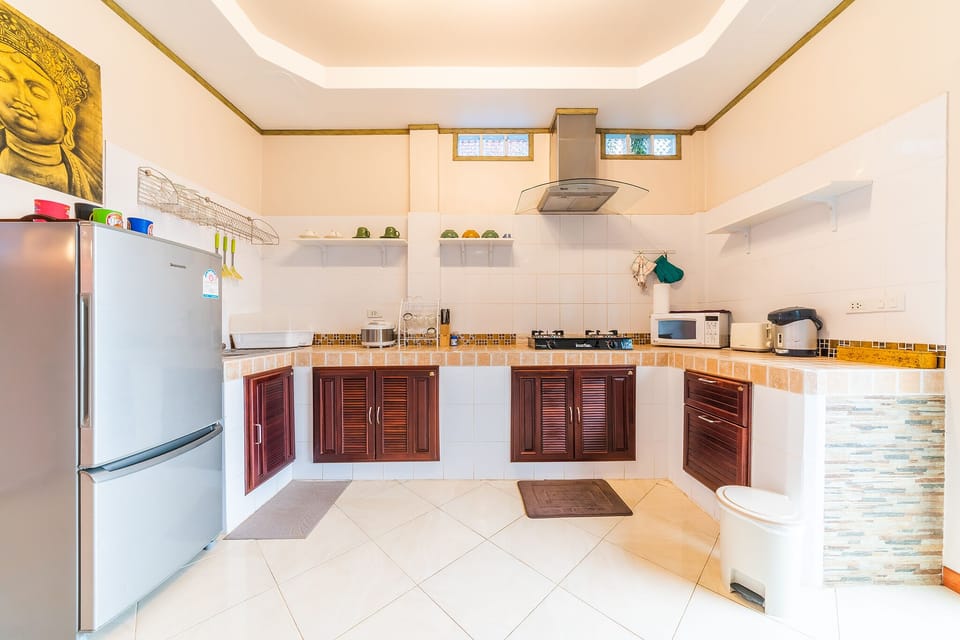1st floor's fully-equipped kitchen with fridge, microwave, stove and utensils