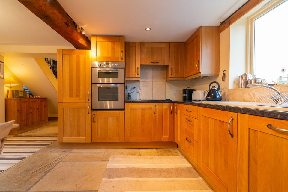 Kitchen area with double electric oven and york flagged floor