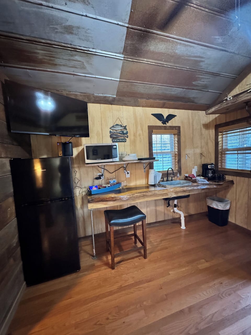 Kitchenette with refrigerator, microwave and drip coffee maker.