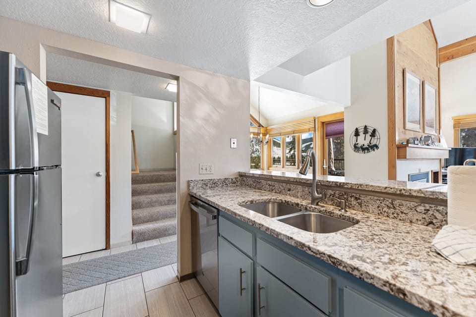 Your fully equipped kitchen features granite counters and stainless appliances, perfect for preparing meals during your mountain getaway.