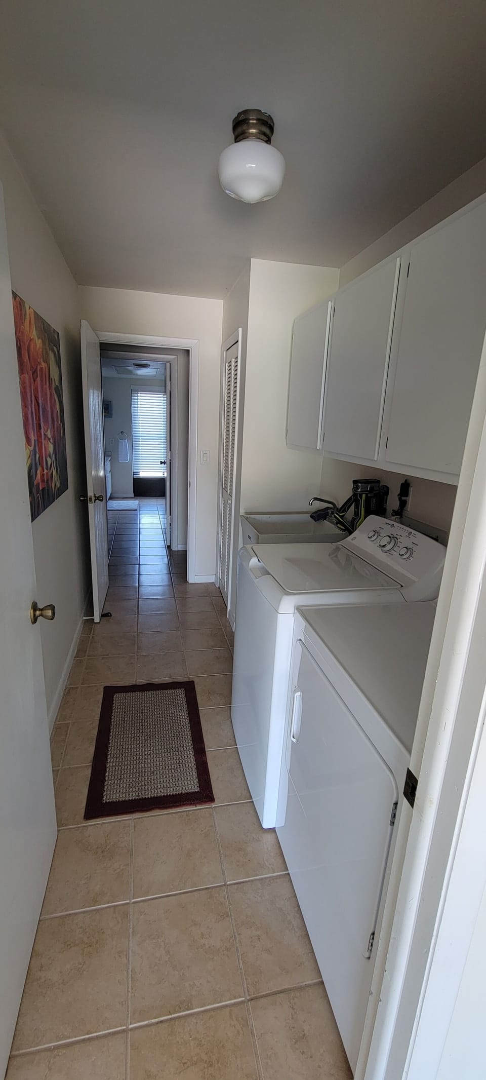Entrance from the garage to laundry room and 2nd bath in the background.